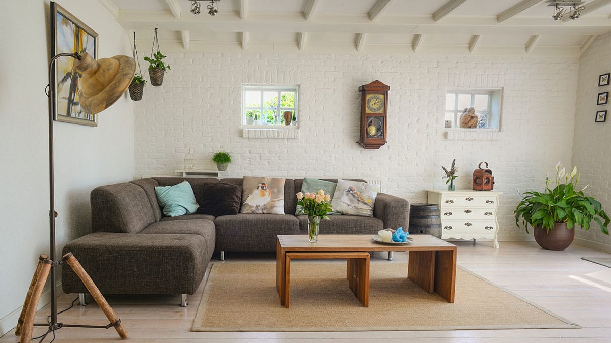 A living room with white walls and a couch.