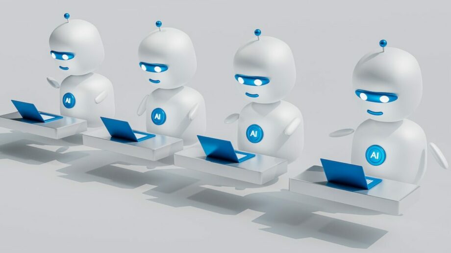 A group of robots with laptops in front of them.