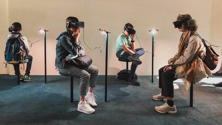 A group of people sitting in a room with vr headsets.