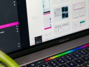 A laptop with a colorful screen and a web design app opened in it.