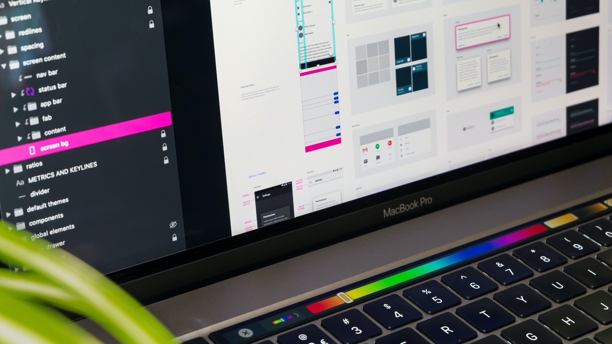 A laptop with a colorful screen and a web design app opened in it.