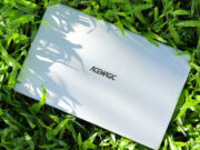 A white ACEMAGIC ‎AX15 Laptop laying in the grass.