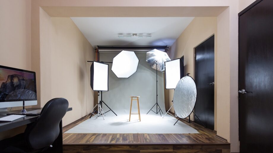 A photo studio with lights and a desk.