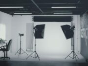 A photo studio with lights and a desk.
